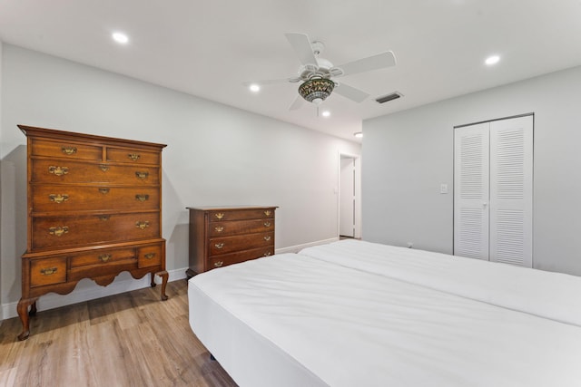 bedroom featuring ceiling fan, a closet, and light hardwood / wood-style flooring