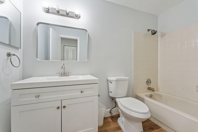 full bathroom with wood-type flooring, vanity, toilet, and tiled shower / bath combo