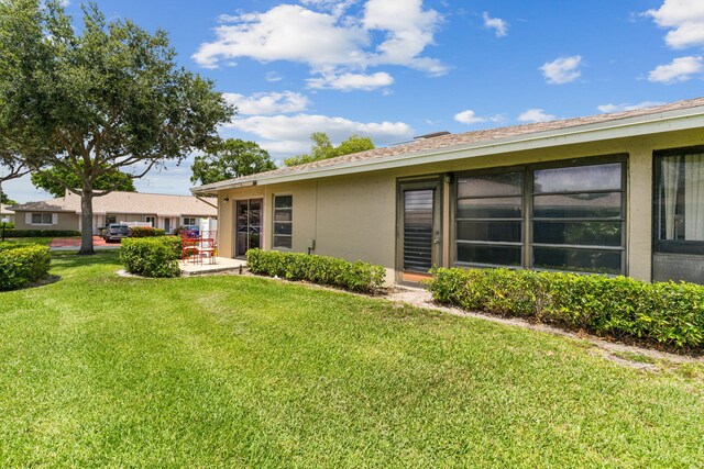 rear view of property with a yard