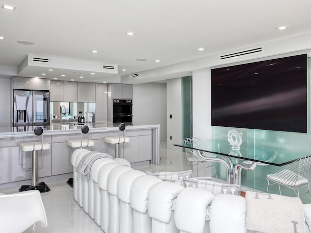 tiled living room featuring sink