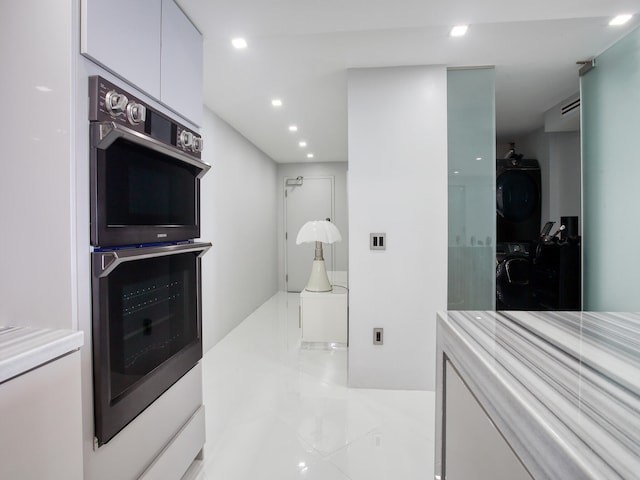 bathroom featuring stacked washing maching and dryer