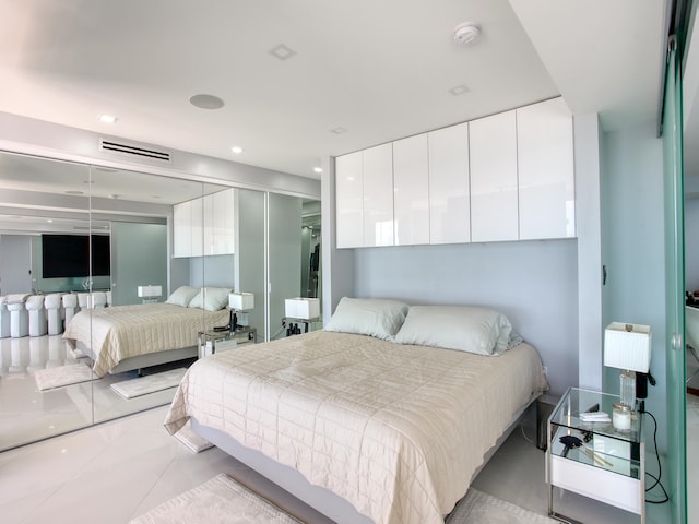 bedroom featuring a closet and light tile patterned floors