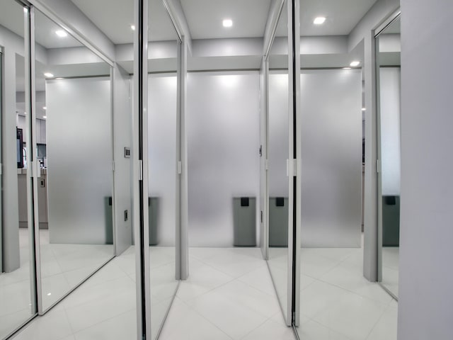 corridor featuring light tile patterned floors