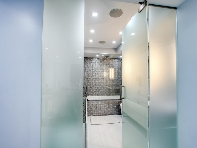 bathroom featuring tile patterned floors and separate shower and tub