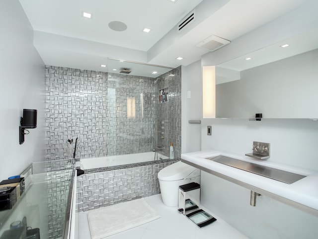 full bathroom featuring tile patterned floors, sink, toilet, and tiled shower / bath