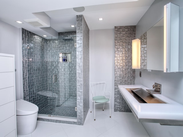 bathroom featuring tile patterned flooring, an enclosed shower, and toilet