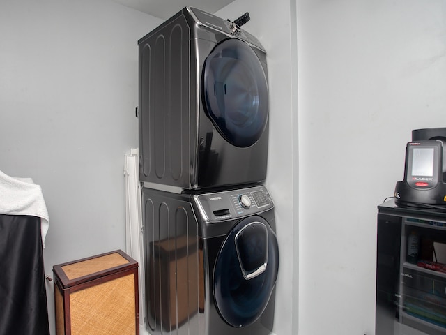 washroom featuring stacked washer and clothes dryer