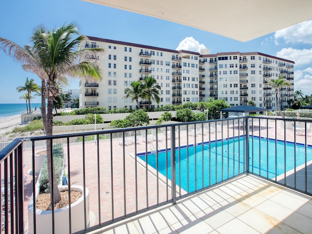 view of swimming pool with a patio area and a water view