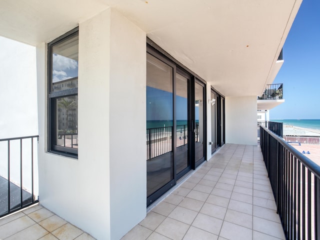 balcony with a beach view and a water view