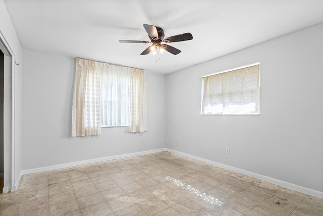 empty room with a wealth of natural light and ceiling fan