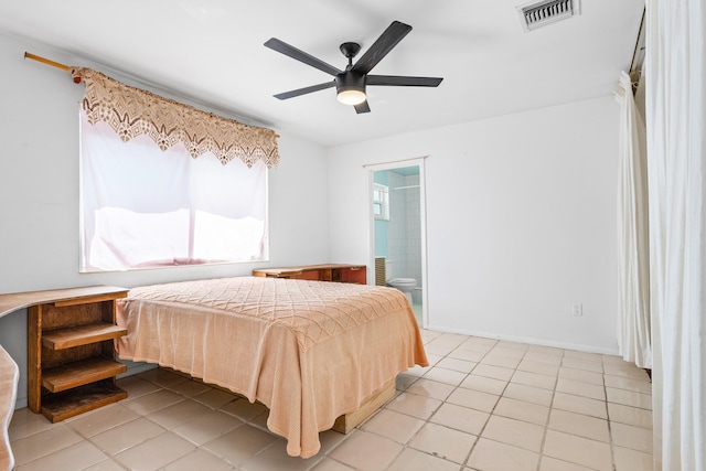 tiled bedroom with connected bathroom and ceiling fan