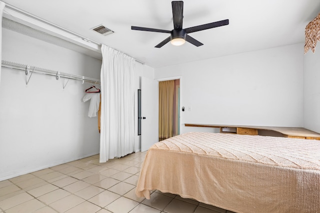 tiled bedroom with a closet and ceiling fan