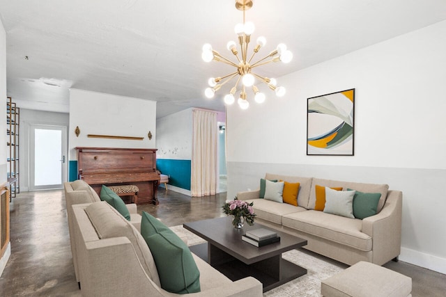 living room with concrete flooring and a notable chandelier