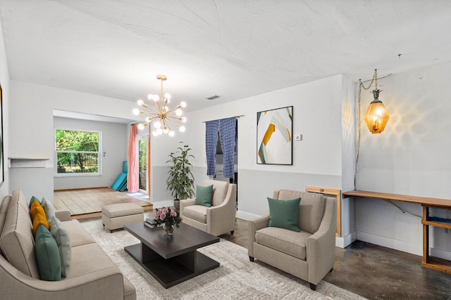 living room featuring concrete flooring and an inviting chandelier