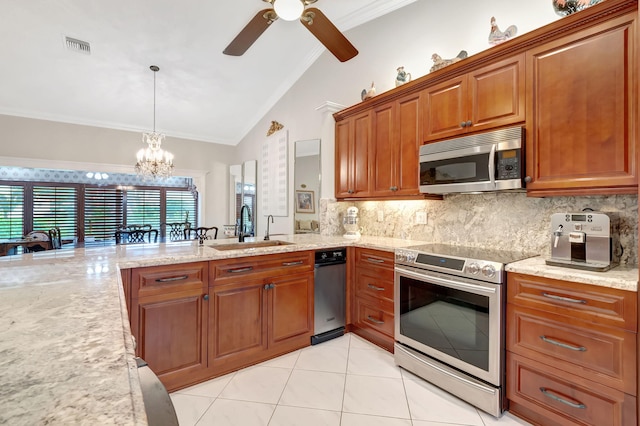 kitchen with pendant lighting, ceiling fan with notable chandelier, sink, ornamental molding, and appliances with stainless steel finishes