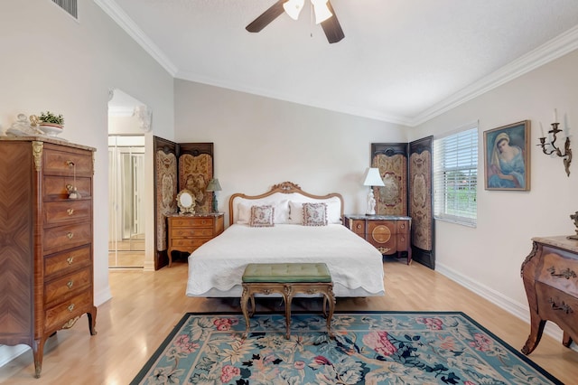 bedroom with ceiling fan, vaulted ceiling, ornamental molding, and light hardwood / wood-style flooring