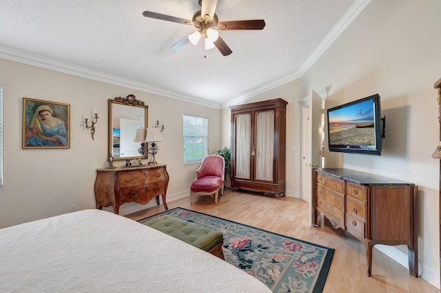 bedroom with ceiling fan, ornamental molding, vaulted ceiling, and light wood-type flooring