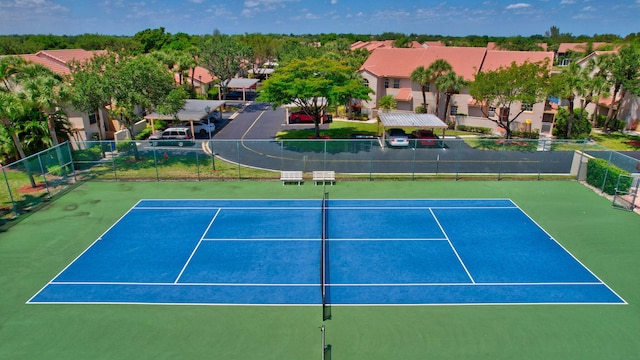 view of tennis court featuring basketball hoop