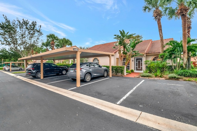 view of parking / parking lot featuring a carport