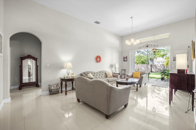 living room featuring a notable chandelier and light tile patterned floors