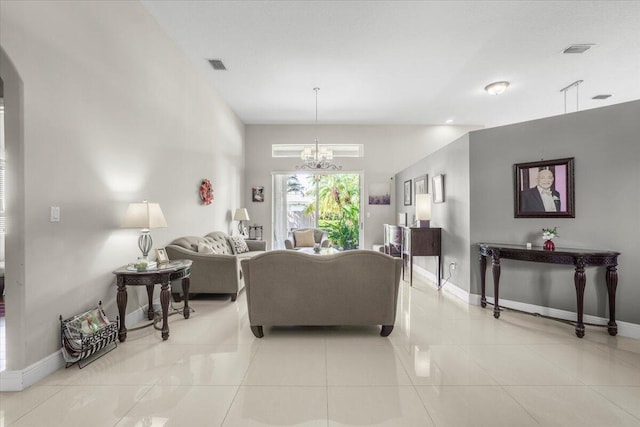 living room with light tile patterned flooring and an inviting chandelier