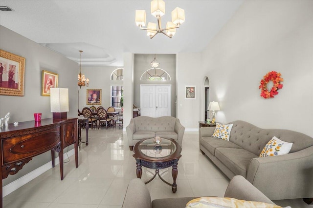 living room with light tile patterned floors and a chandelier