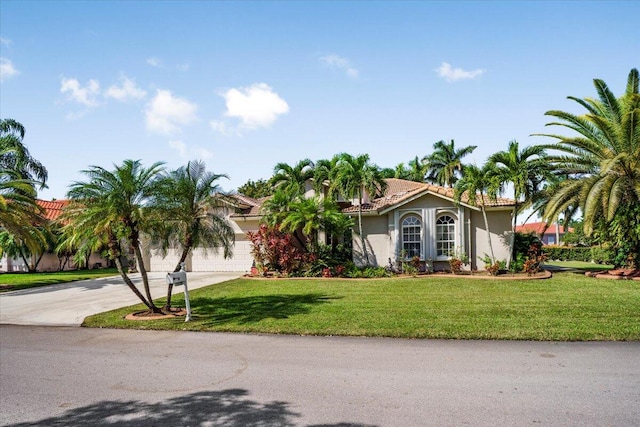 view of front facade featuring a front yard and a garage