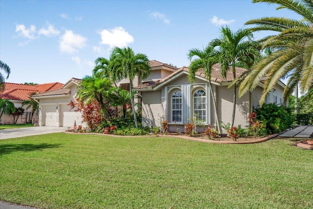 mediterranean / spanish-style house with a garage and a front yard