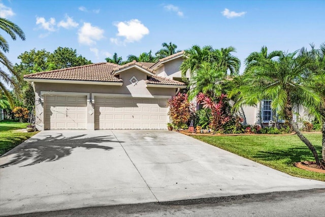 mediterranean / spanish home with a garage and a front lawn