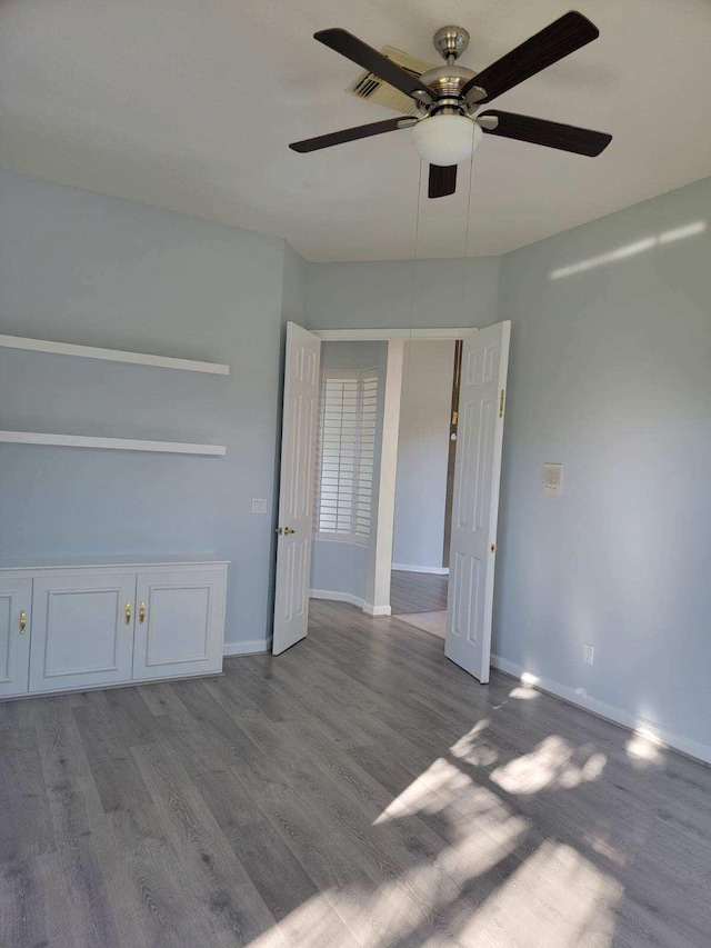 interior space with wood-type flooring and ceiling fan