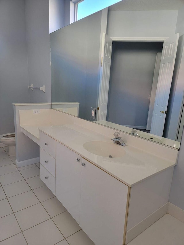 bathroom featuring tile patterned floors, vanity, and toilet