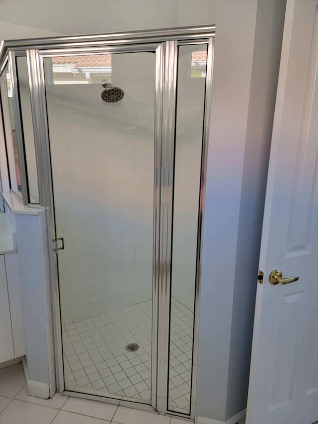 bathroom featuring tile patterned floors and an enclosed shower