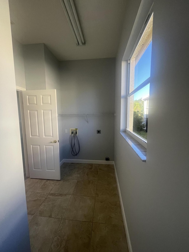 washroom featuring tile patterned floors, washer hookup, and hookup for an electric dryer