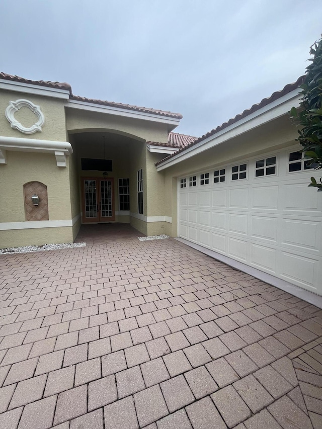 view of exterior entry with a garage