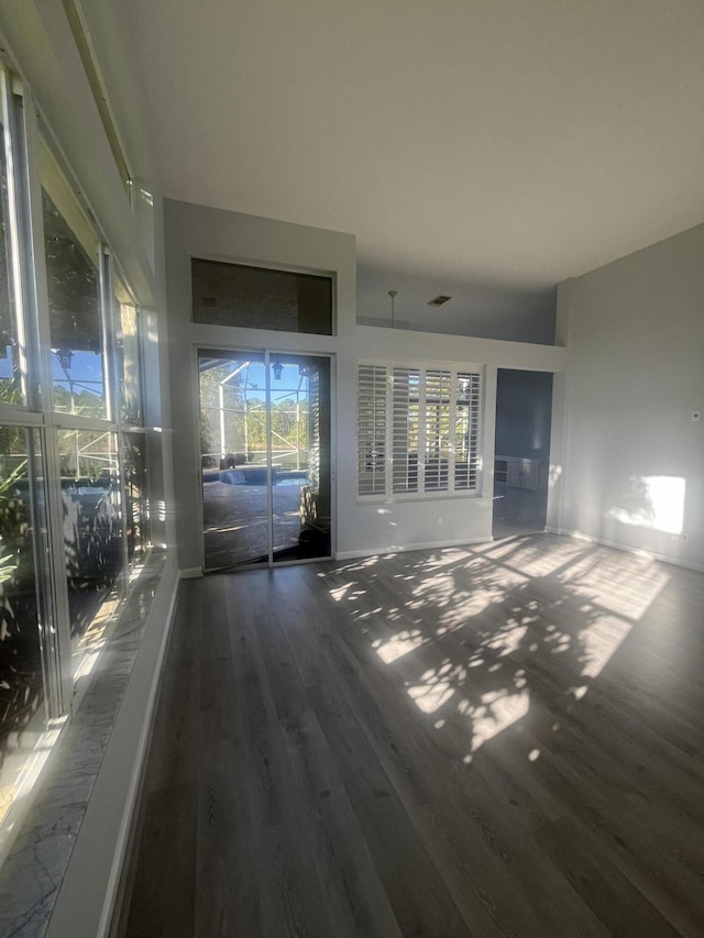 unfurnished living room featuring dark hardwood / wood-style floors