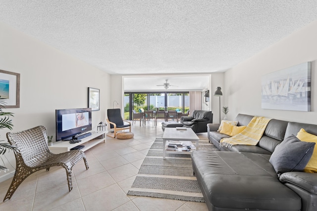 tiled living room featuring ceiling fan and a textured ceiling