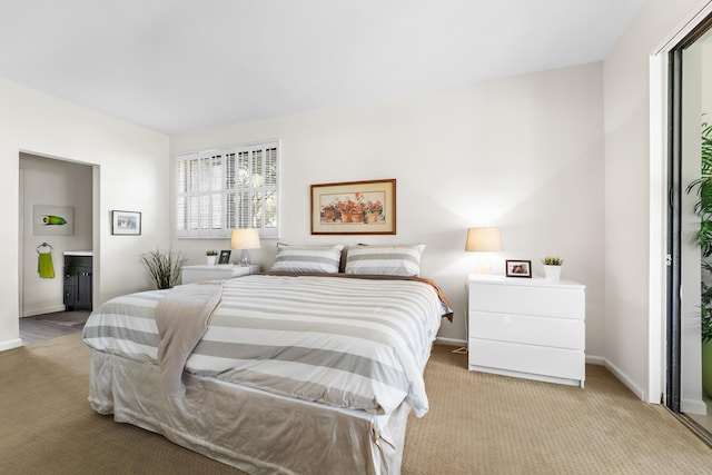 carpeted bedroom featuring ensuite bath