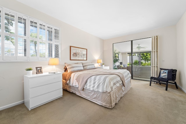 bedroom featuring access to exterior and light carpet