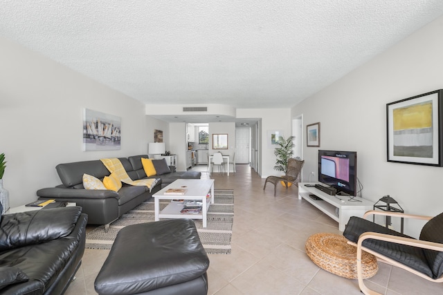 tiled living room with a textured ceiling