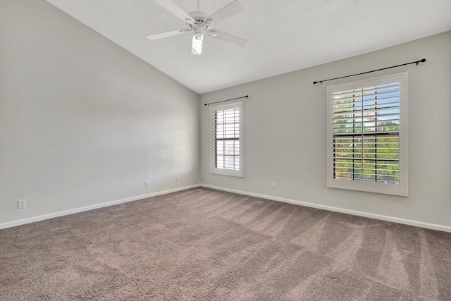 unfurnished room with ceiling fan, carpet floors, a textured ceiling, and vaulted ceiling