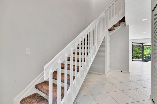 stairway featuring tile patterned flooring