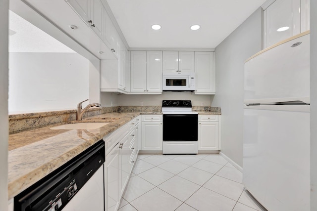 kitchen with sink, light stone counters, light tile patterned flooring, white appliances, and white cabinets