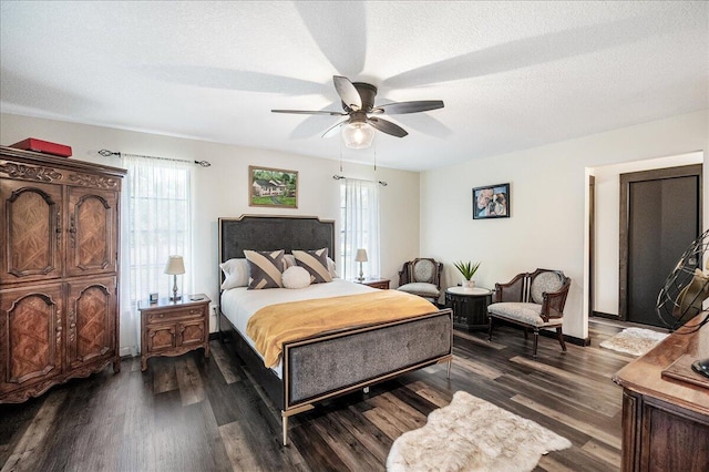 bedroom featuring a textured ceiling, dark hardwood / wood-style flooring, and ceiling fan