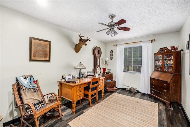 office space featuring a textured ceiling, dark hardwood / wood-style flooring, and ceiling fan