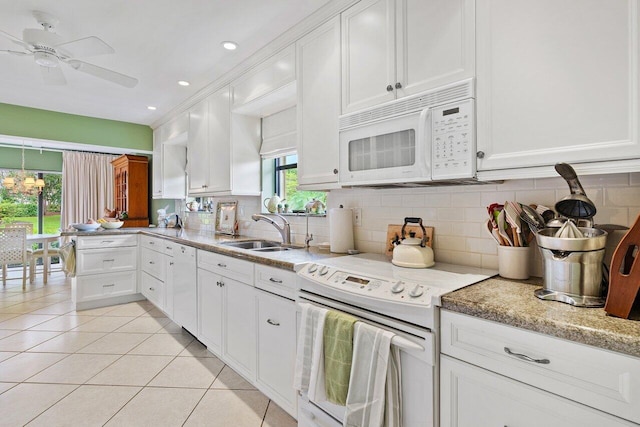 kitchen with sink, light tile patterned floors, white appliances, decorative backsplash, and white cabinets