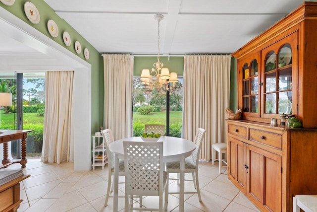 dining space with a notable chandelier and light tile patterned floors