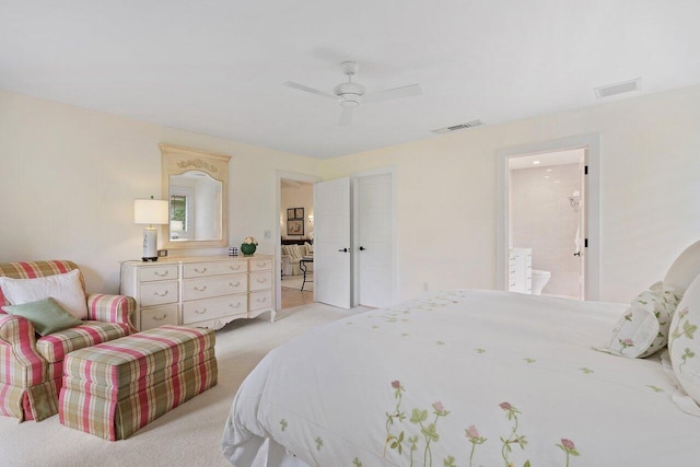 bedroom featuring light carpet, connected bathroom, and ceiling fan