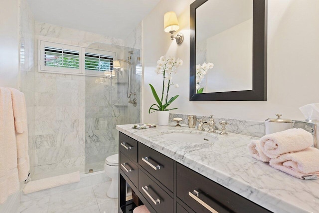 bathroom featuring vanity, toilet, and tiled shower