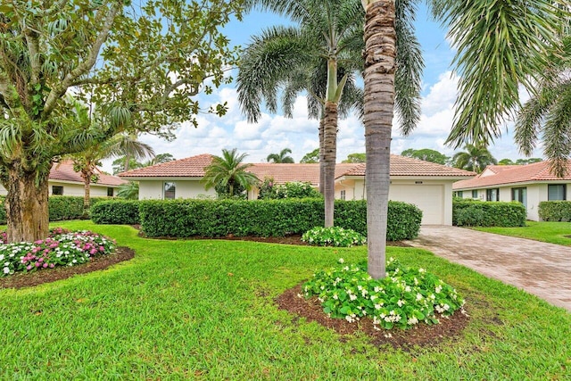 view of front of house featuring a front yard and a garage