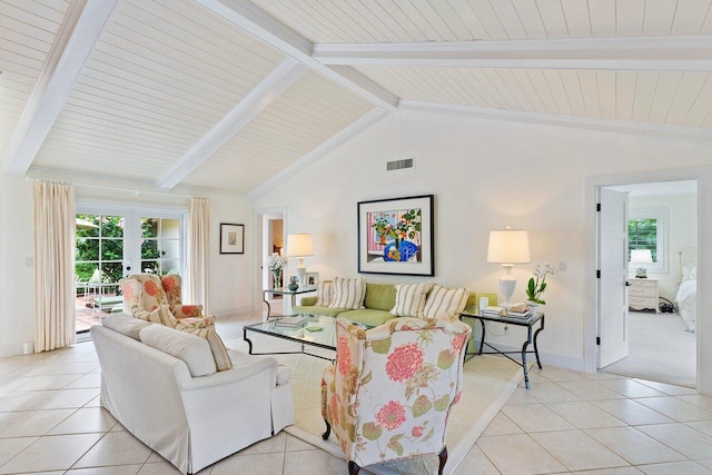 living room featuring vaulted ceiling with beams, a healthy amount of sunlight, light tile patterned floors, and french doors